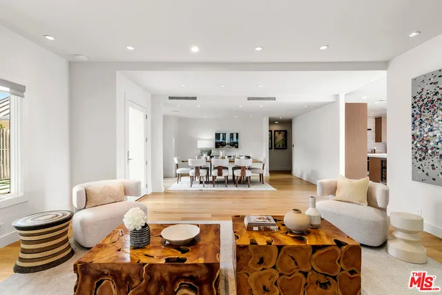 a living room with furniture and kitchen view