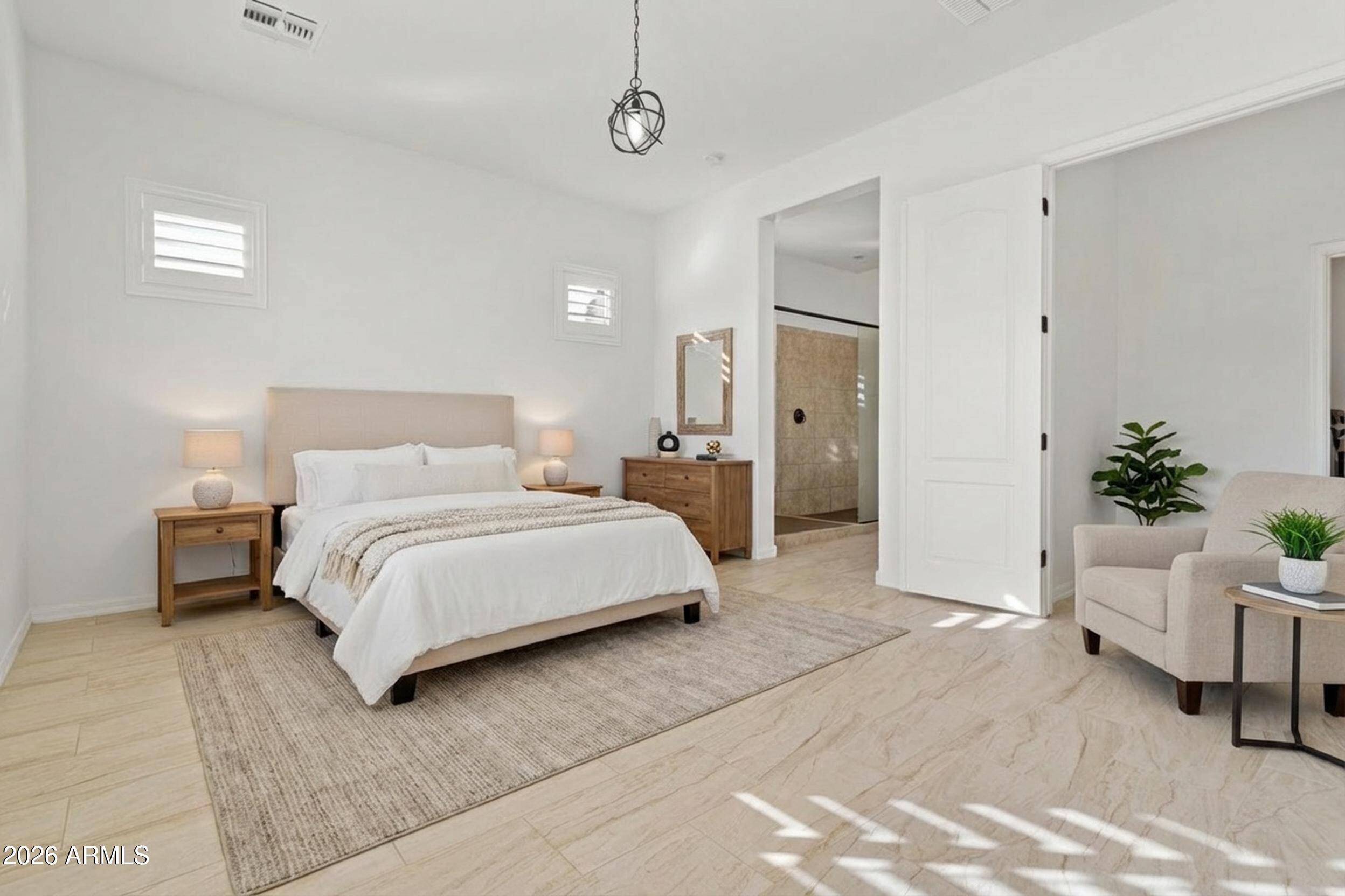 20537 West Valley View Drive Buckeye, AZ 85396 - Photo 13 of 32 a bedroom with a bed and a couch