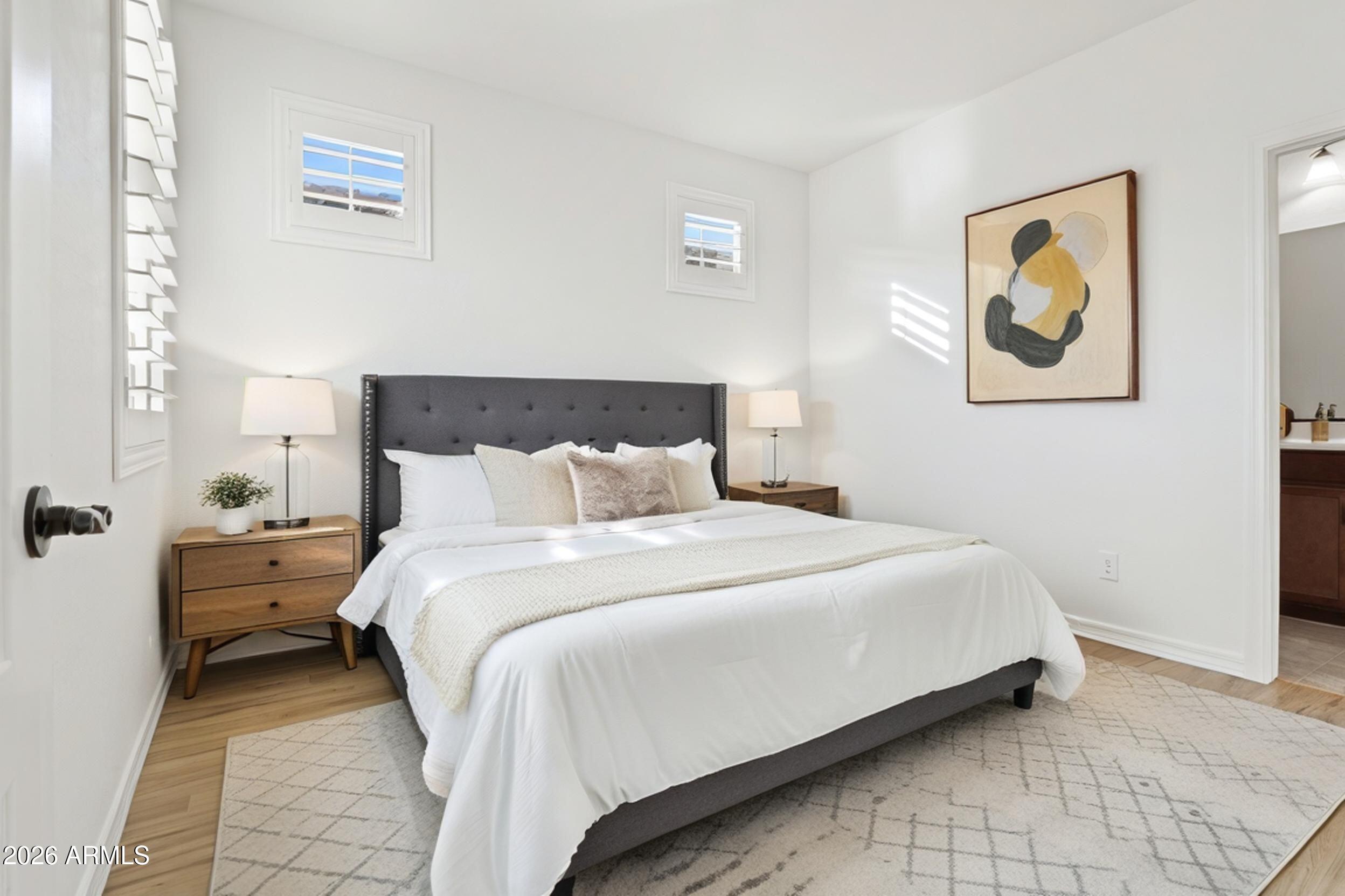 20537 West Valley View Drive Buckeye, AZ 85396 - Photo 20 of 32 a bedroom with bed and wall painting