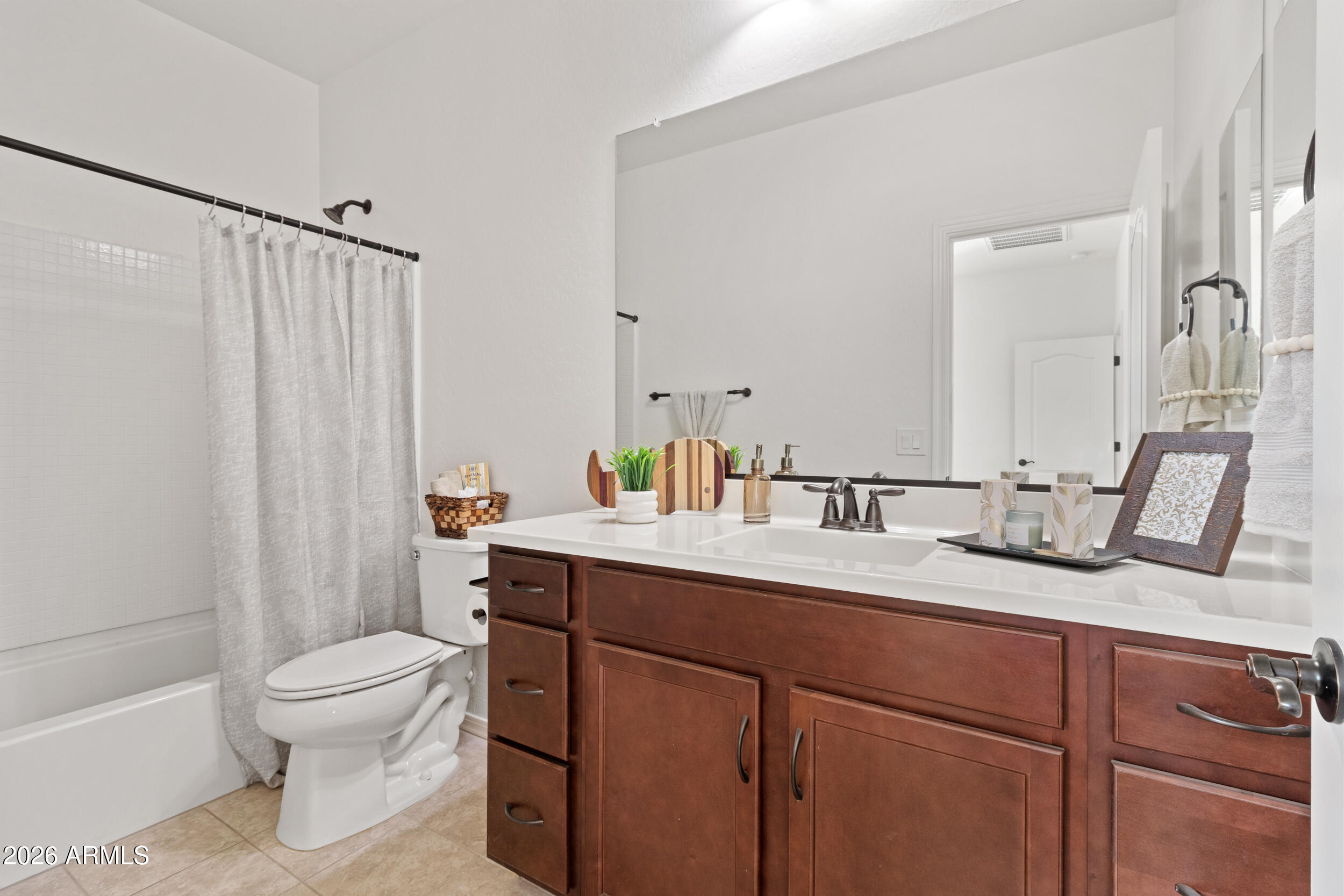 20537 West Valley View Drive Buckeye, AZ 85396 - Photo 21 of 32 a bathroom with a granite countertop sink a toilet and a mirror