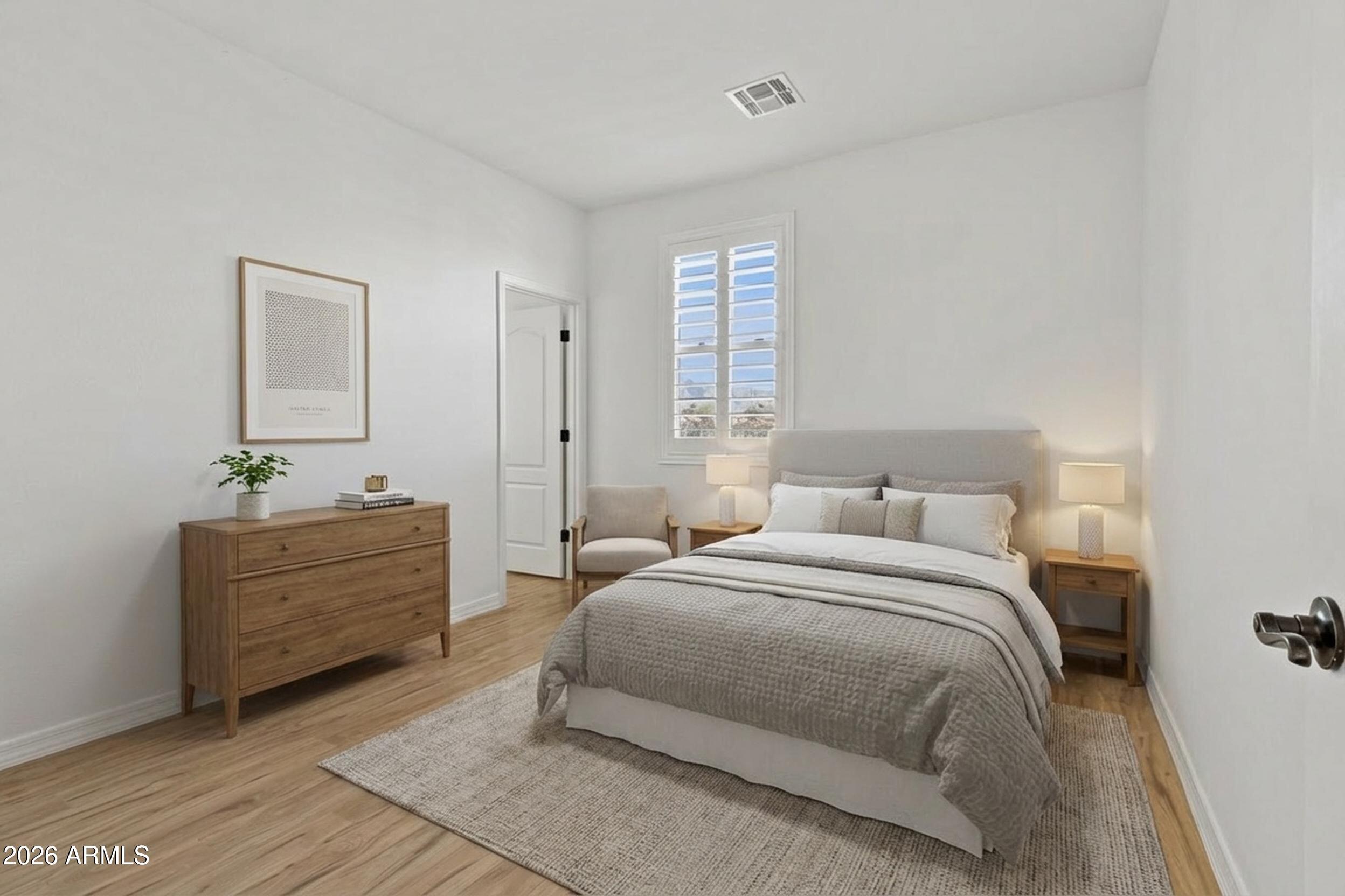 20537 West Valley View Drive Buckeye, AZ 85396 - Photo 23 of 32 a spacious bedroom with a bed and a window