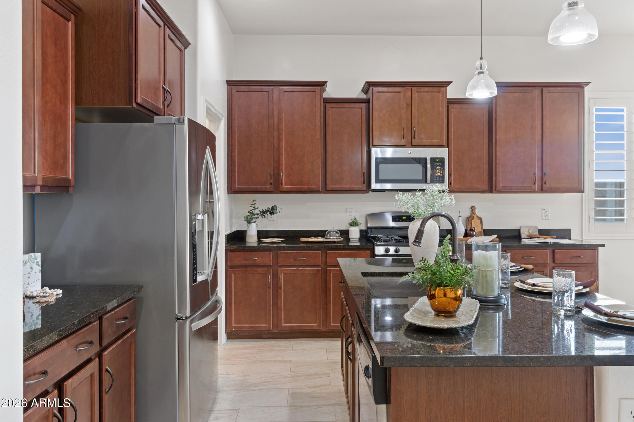 20537 West Valley View Drive Buckeye, AZ 85396 - Photo 8 of 32 a kitchen with stainless steel appliances granite countertop a sink stove and refrigerator