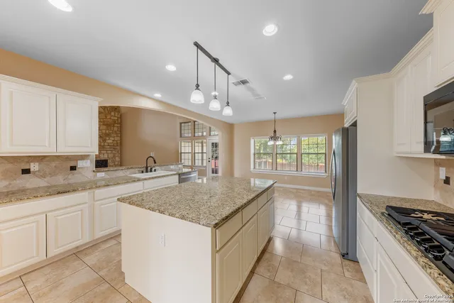 a kitchen with a sink stove and cabinets