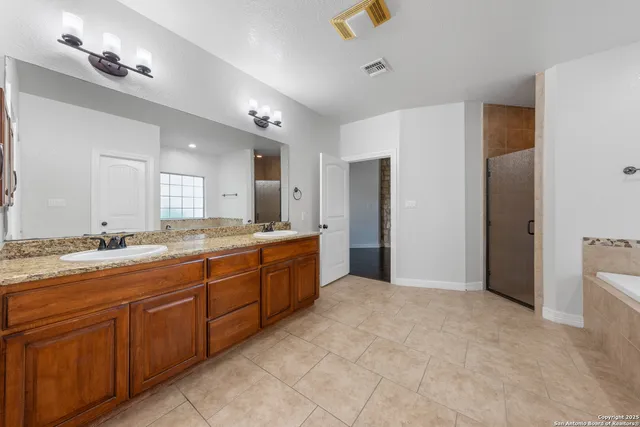 a large bathroom with a granite countertop sink mirror and a