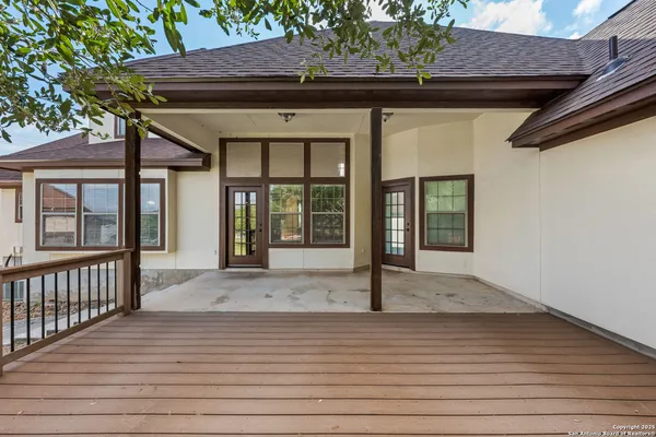 a view of a house with a wooden deck