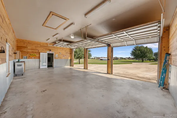 a view of a hall with wooden floor