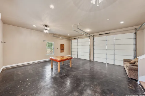 an empty room with projector and furniture