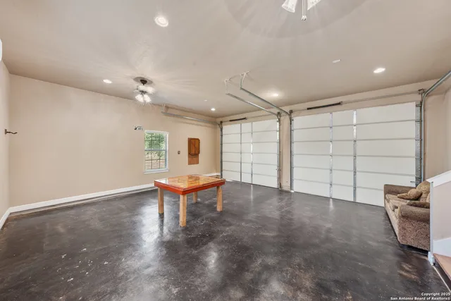 an empty room with projector and furniture