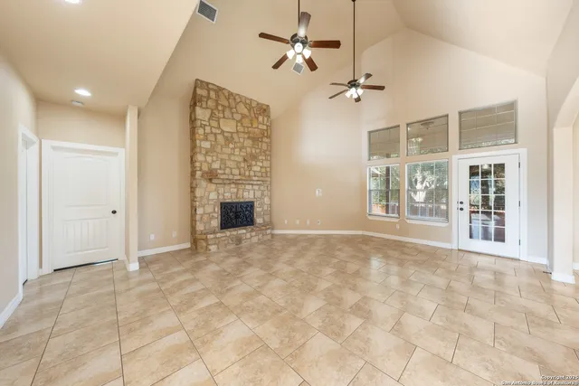 a view of an empty room with a fireplace