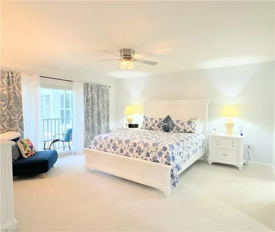 a bedroom with a bed and ceiling fan