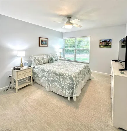 a bedroom with a bed table and window