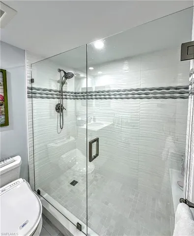 a bathroom with a shower a toilet and a sink