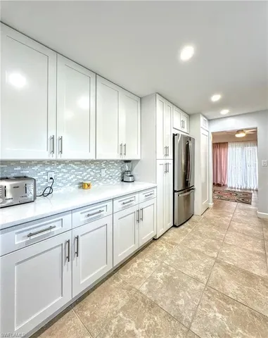a large kitchen with cabinets appliances and a counter space