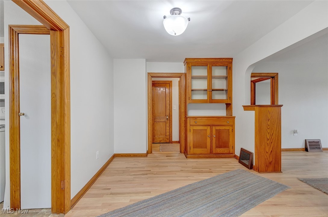 43800 Middle Ridge Road Lorain, OH 44053 - Photo 13 of 31 Dining room featuring light refinished wood flooring and baseboards and built-in hutch