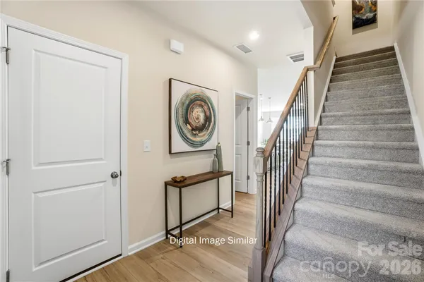 a view of a hallway with wooden floor and entryway