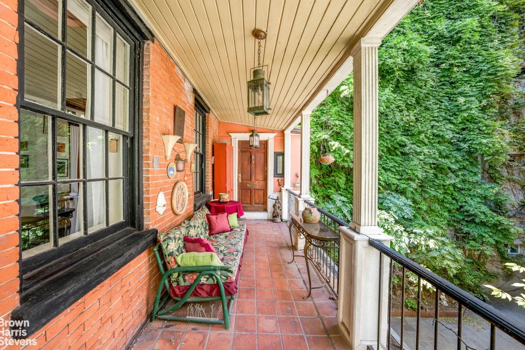 422 West 46th Street, Unit 2R Manhattan, NY 10036 - Photo 2 of 10 a balcony with furniture and garden view
