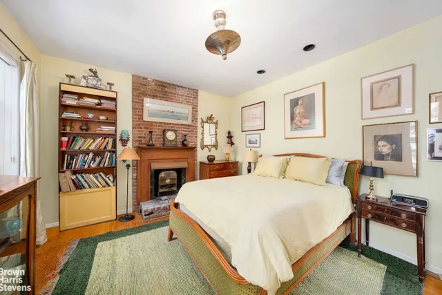 a bed room with a bed and a fireplace