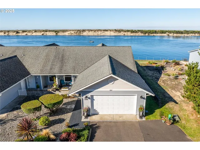 a view of a terrace with a table and chairs under an umbrella