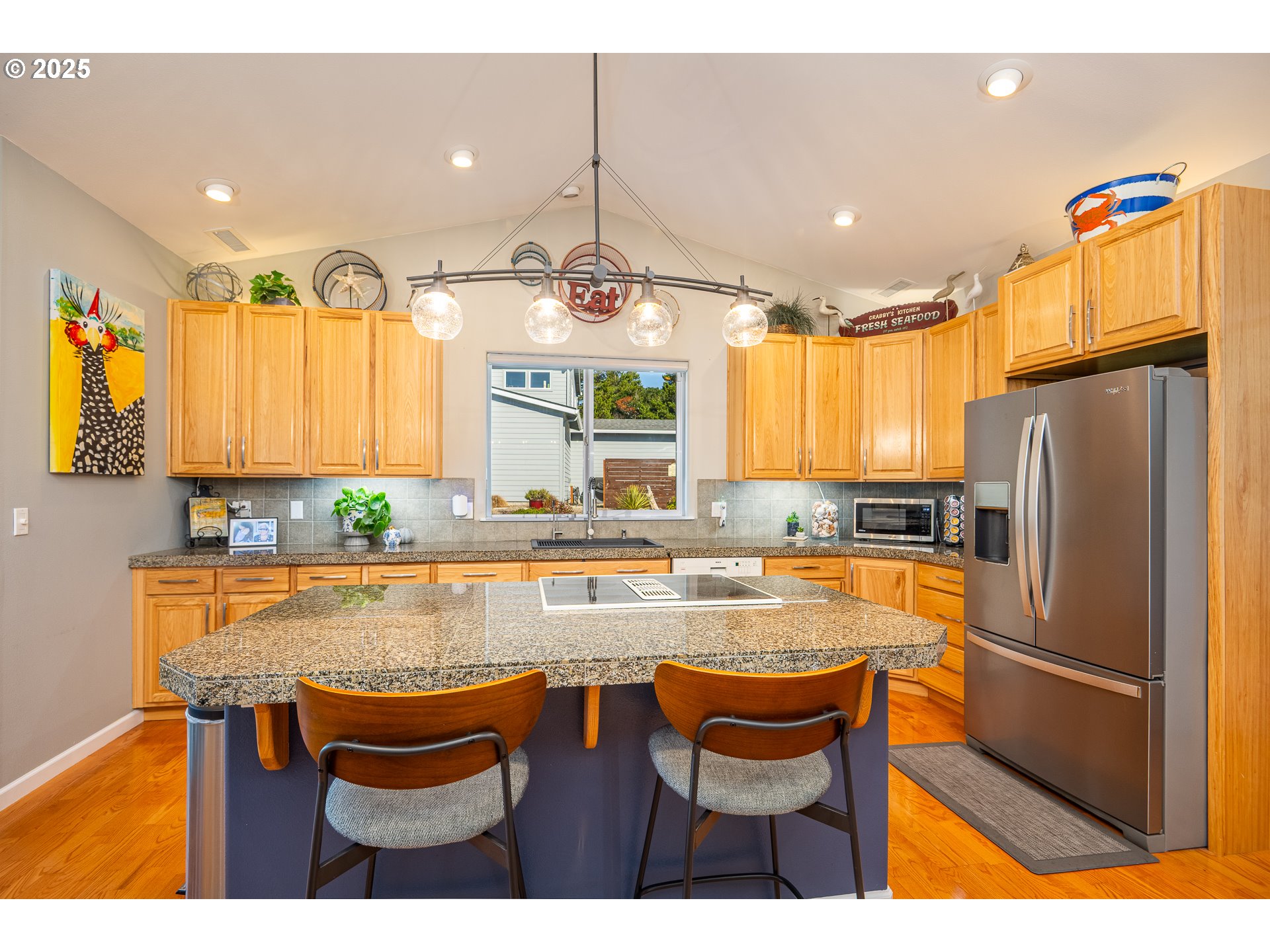 3315 Rhododendron Drive Florence, OR 97439 - Photo 20 of 48 a kitchen with granite countertop wooden cabinets and stainless steel appliances