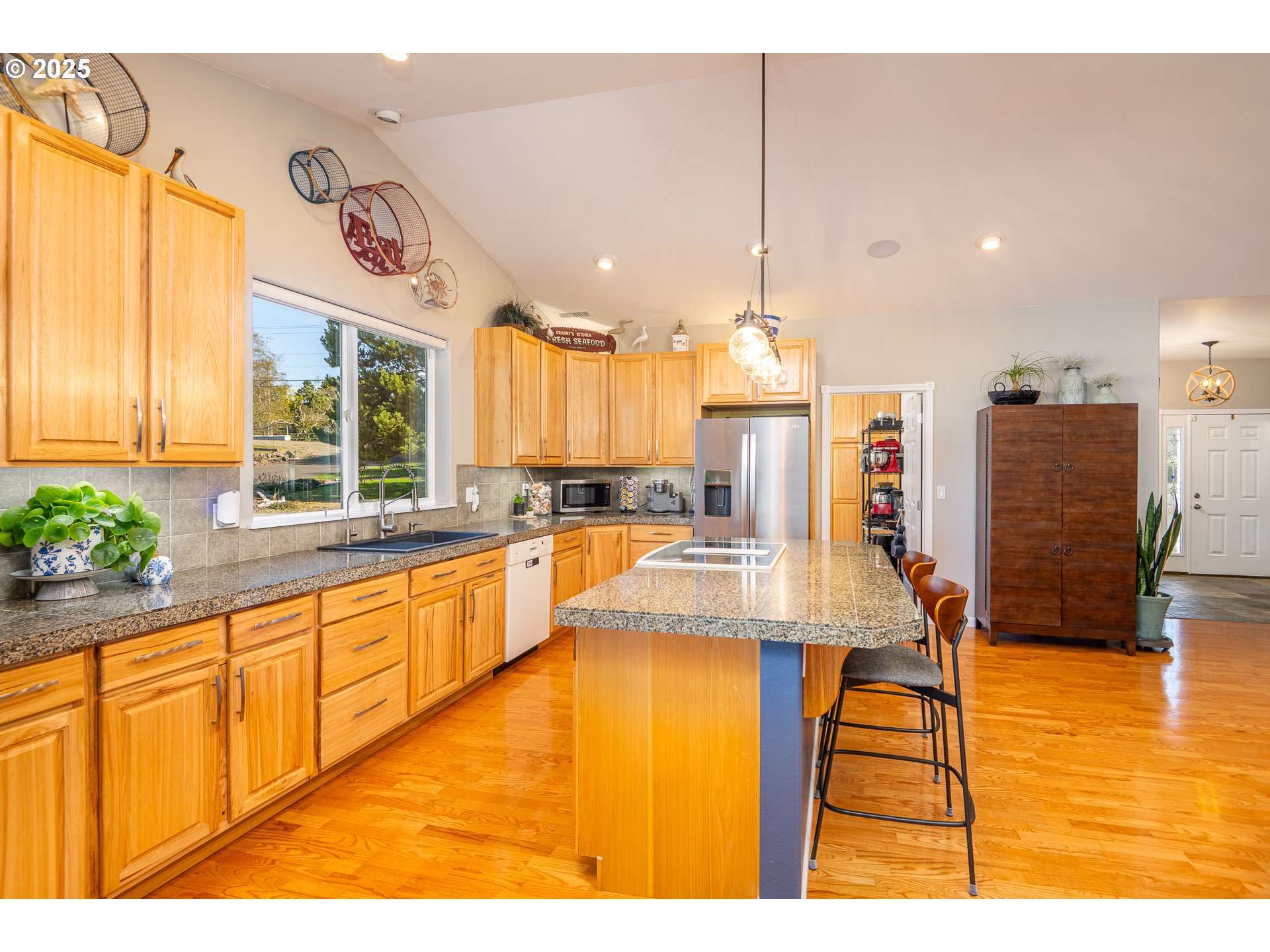 3315 Rhododendron Drive Florence, OR 97439 - Photo 21 of 48 a large kitchen with a large window cabinets and stainless steel appliances