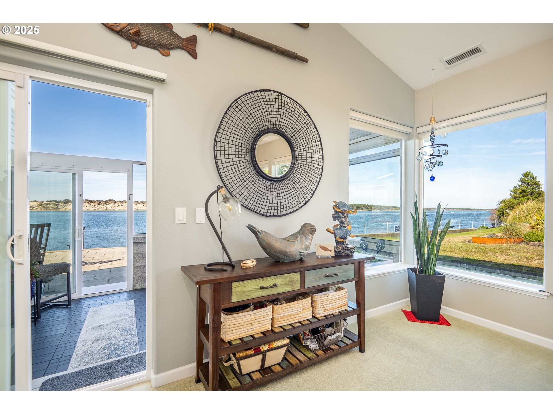 3315 Rhododendron Drive Florence, OR 97439 - Photo 28 of 48 a living room with furniture a rug and a floor to ceiling window