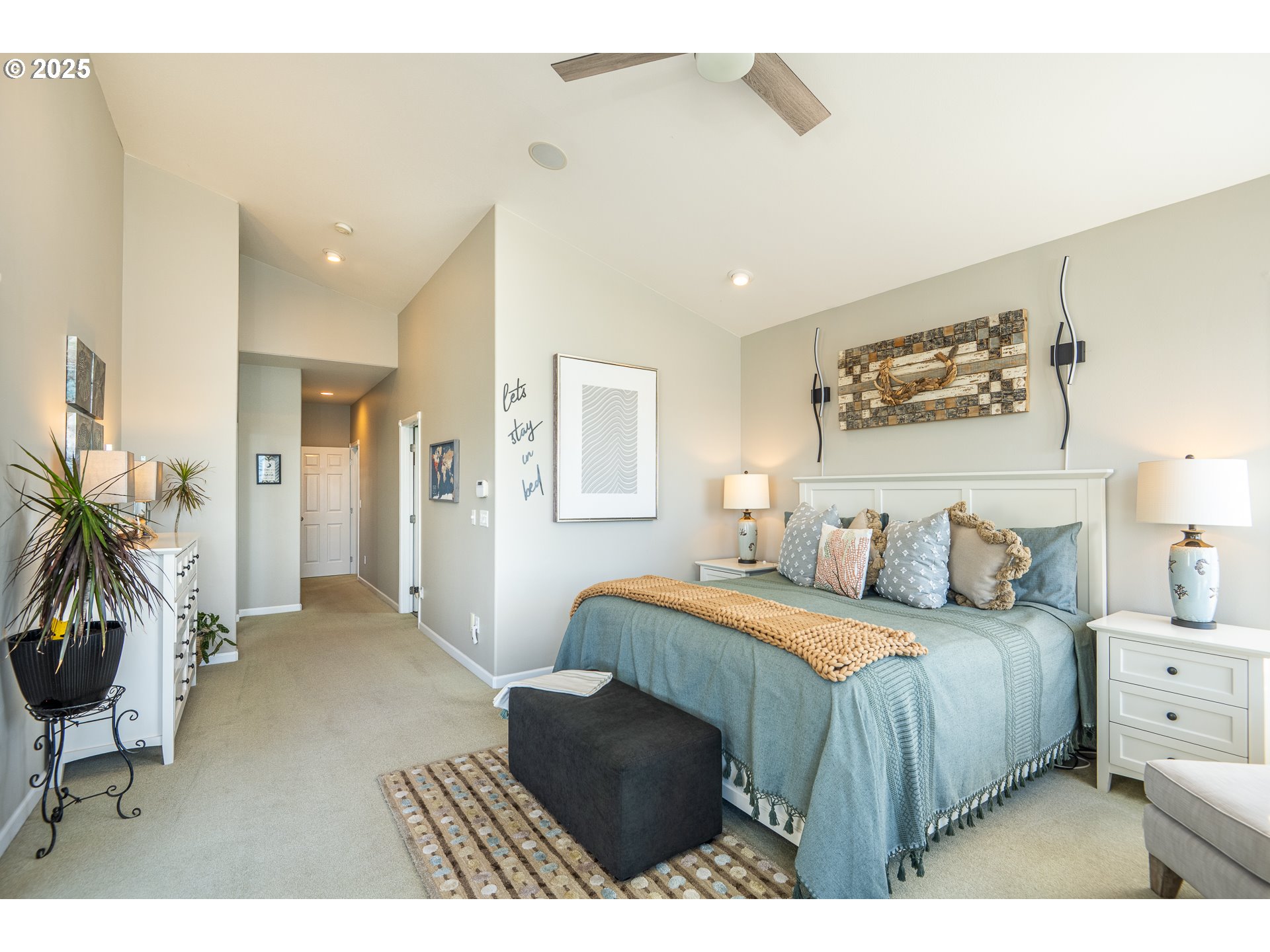 3315 Rhododendron Drive Florence, OR 97439 - Photo 30 of 48 a bedroom with a bed and a potted plant