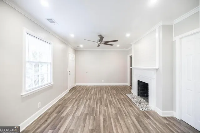 wooden floor in an empty room with a fireplace