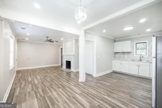 a view of a kitchen with a sink dishwasher a refrigerator with wooden cabinets