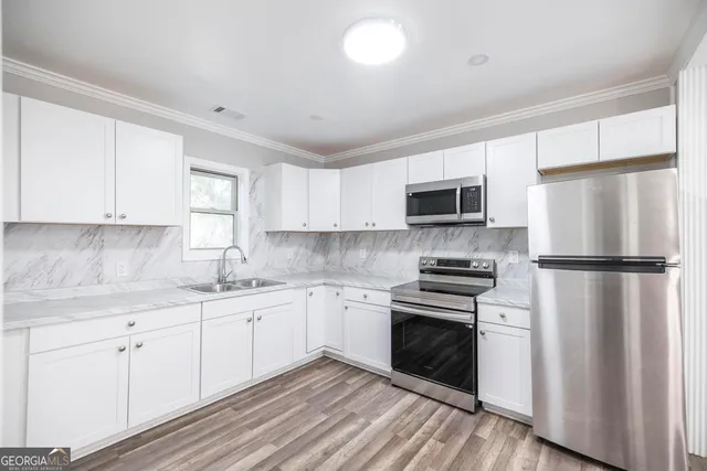 a kitchen with a sink stove and refrigerator