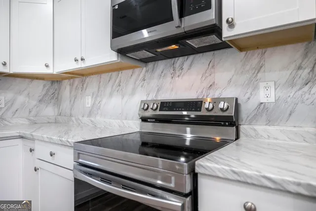 a stove top oven sitting inside of a kitchen