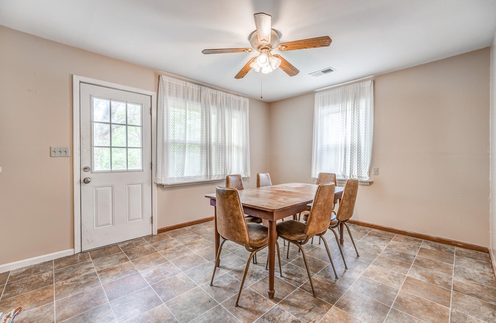 6125 Warren Road Oakland, TN 38060 - Photo 11 of 40 Versatile dining area featuring neutral wall tones, multi-tone tile flooring, and a ceiling fan with light fixture