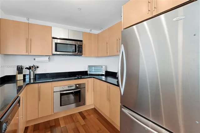 a kitchen with stainless steel appliances a refrigerator sink and microwave