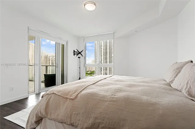 a bedroom with a large bed and a window