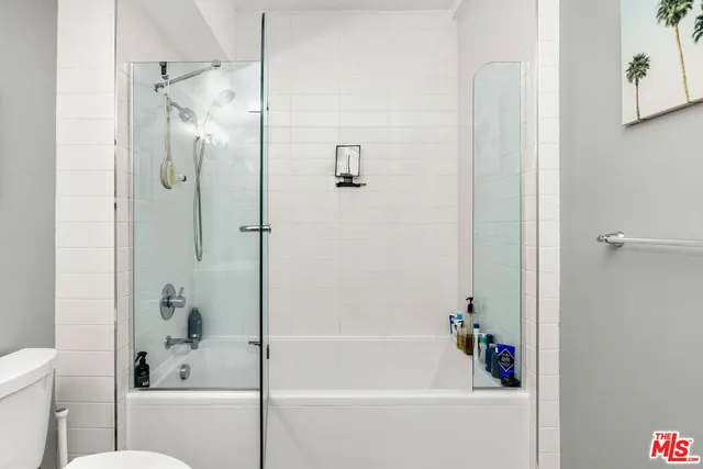a bathroom with a bathtub with a shower