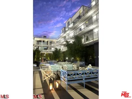 a view of a patio with table and chairs and potted plants