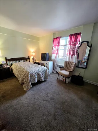 a bedroom with bed and window