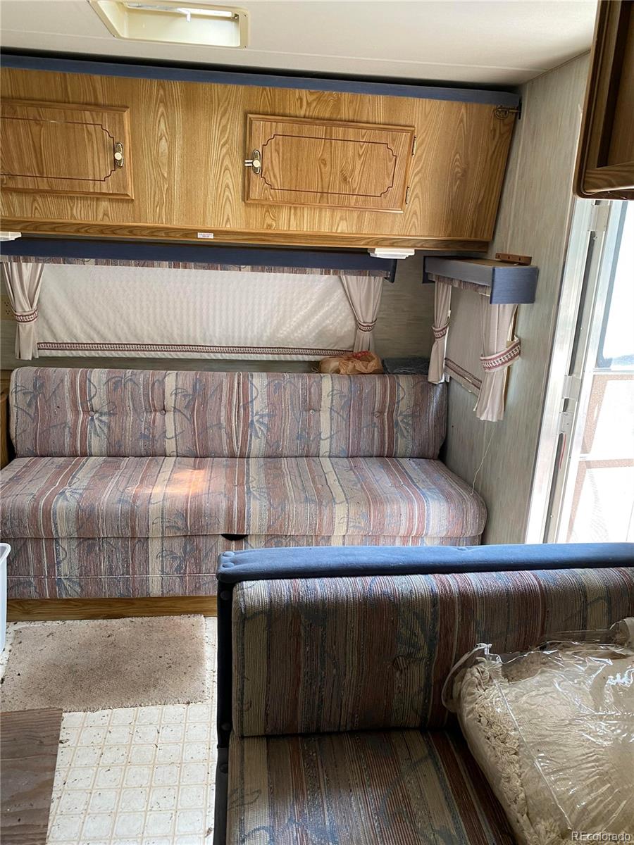 50 County Road Como, CO 80432 - Photo 12 of 25 a living room with a couch and a rug