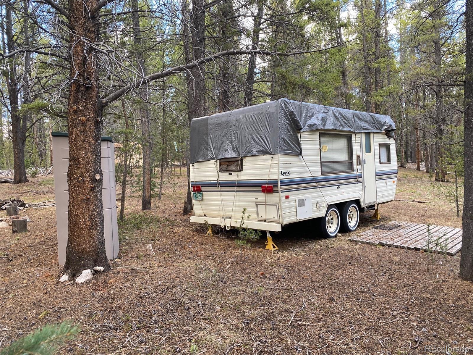 50 County Road Como, CO 80432 - Photo 10 of 25 a view of a house with a yard and sitting area