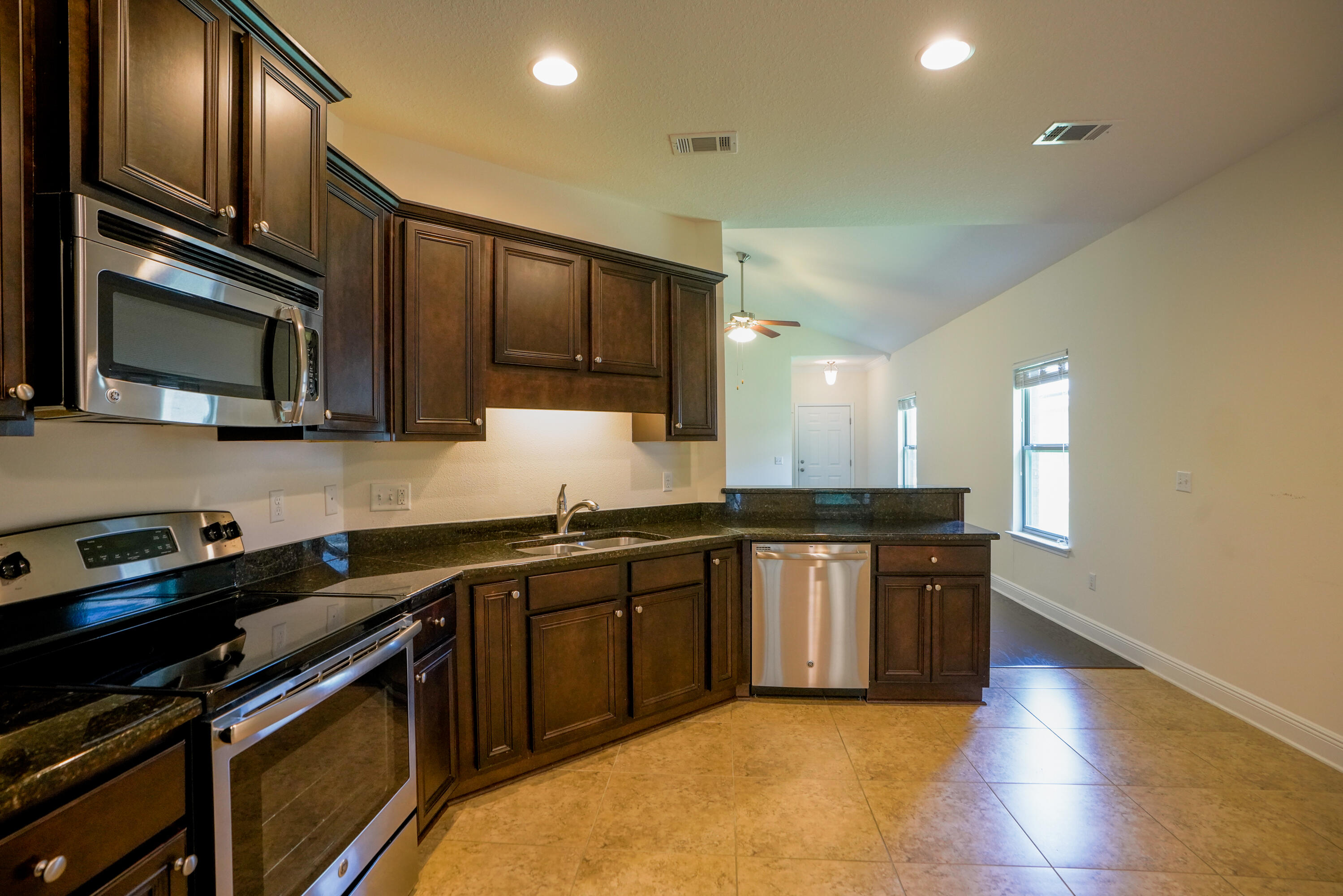 122 Riverbirch Loop Santa Rosa Beach, FL 32459 - Photo 11 of 41 a kitchen with stainless steel appliances granite countertop a stove top oven microwave and sink