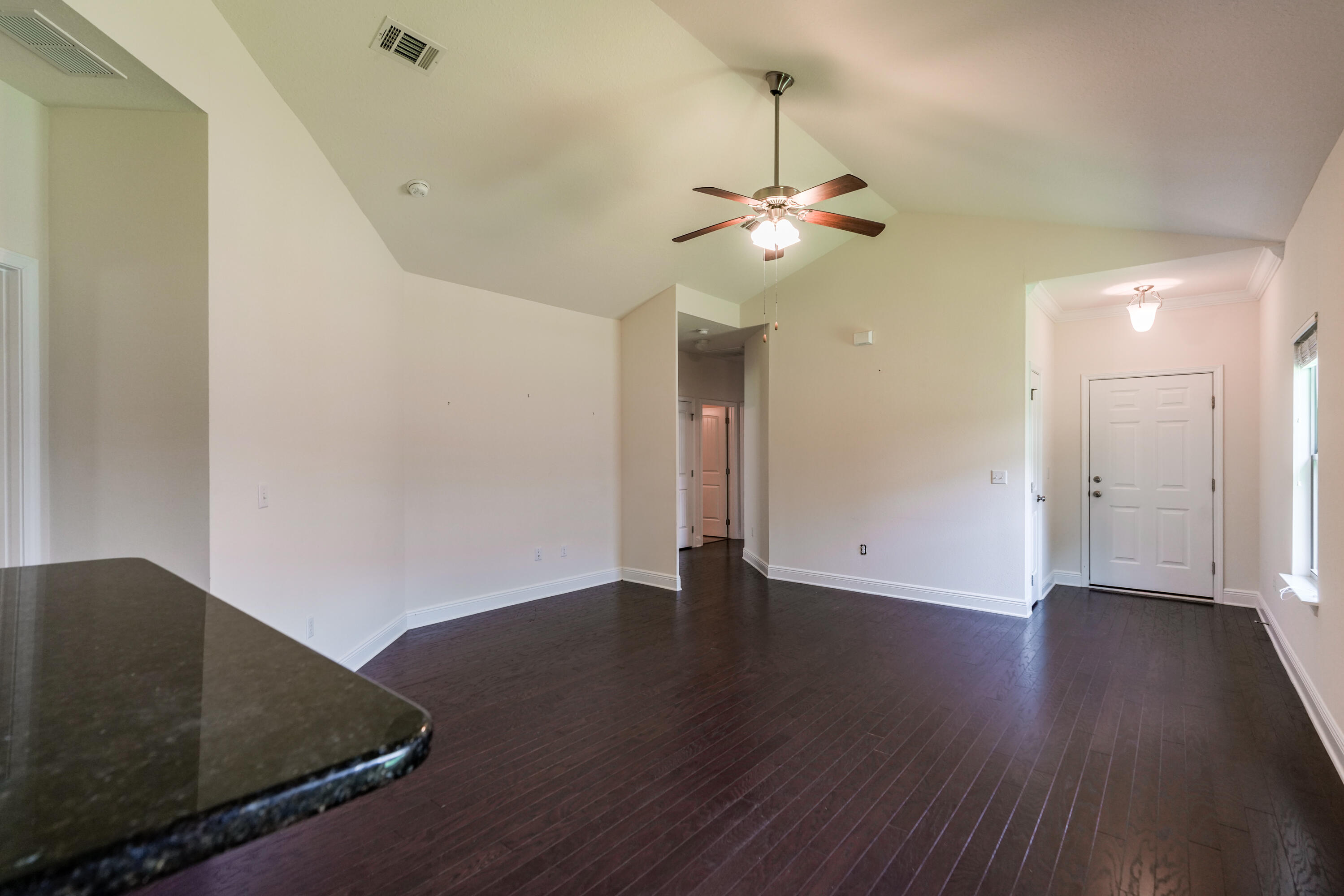 122 Riverbirch Loop Santa Rosa Beach, FL 32459 - Photo 5 of 41 a view of a room with wooden floor and ceiling fan