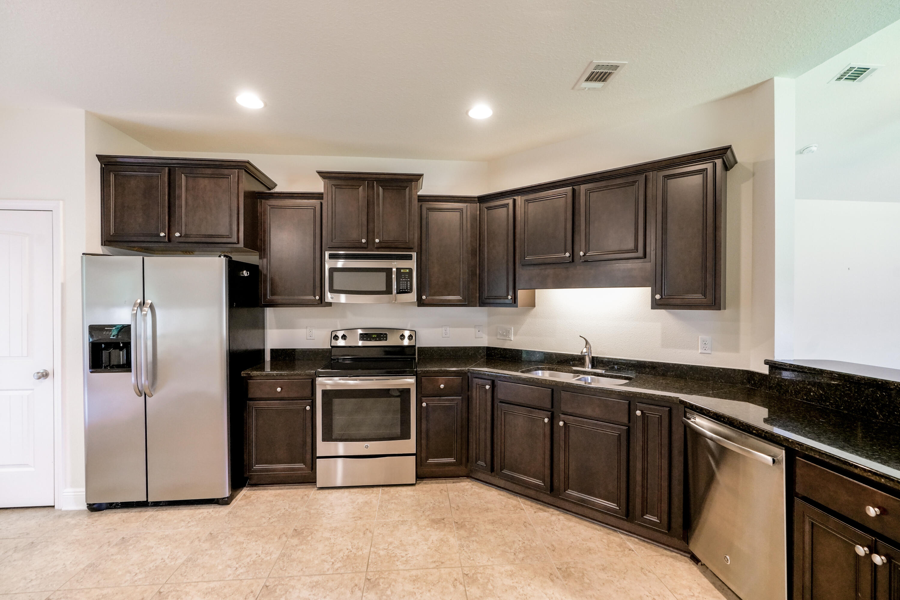 122 Riverbirch Loop Santa Rosa Beach, FL 32459 - Photo 9 of 41 a kitchen with stainless steel appliances granite countertop a sink stove and refrigerator
