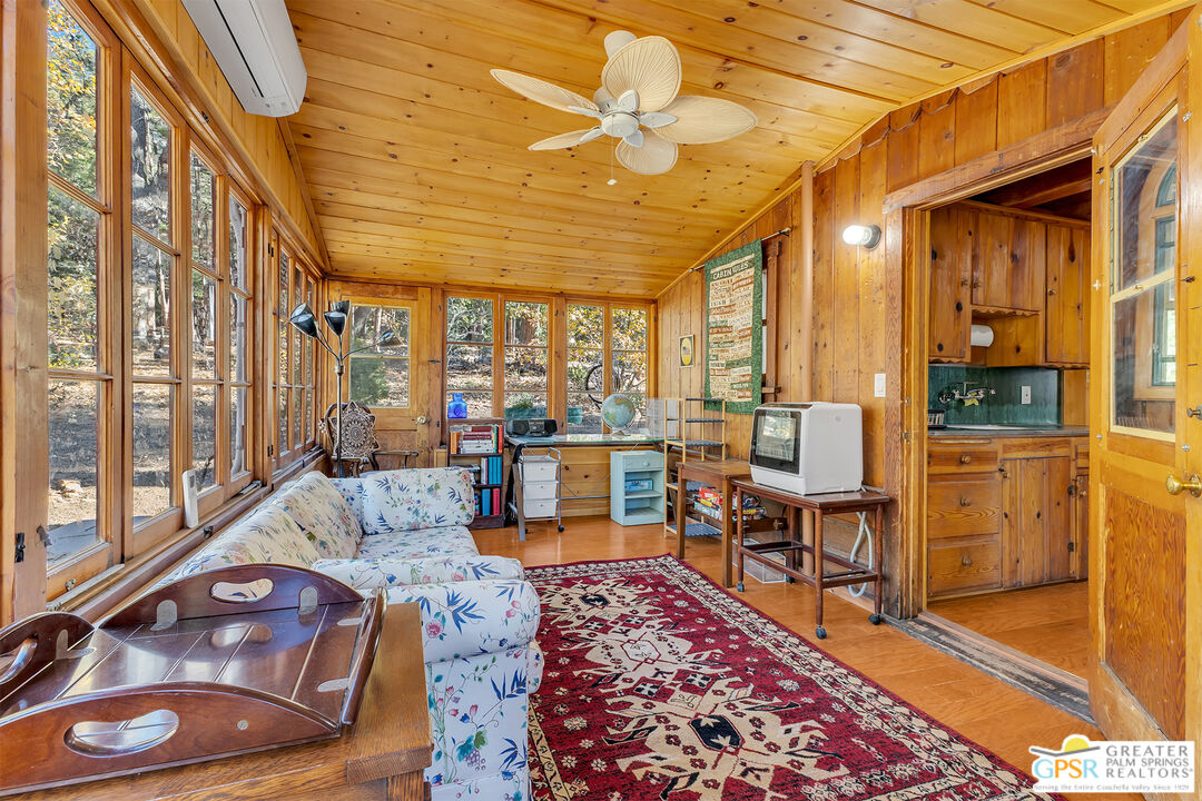 25250 Rim Rock Road Idyllwild, CA 92549 - Photo 13 of 72 a living room with furniture and a large window