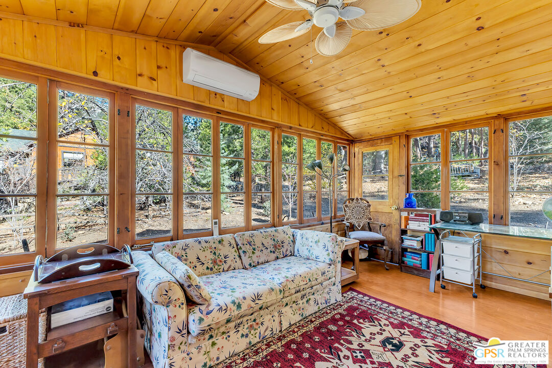 25250 Rim Rock Road Idyllwild, CA 92549 - Photo 14 of 72 a living room with furniture and a large window