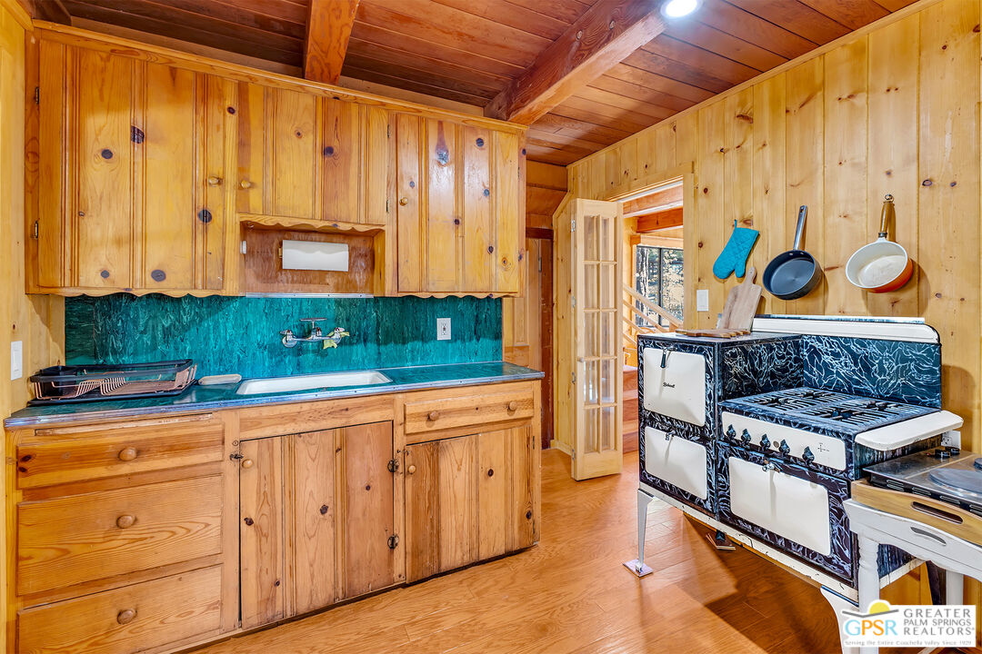 25250 Rim Rock Road Idyllwild, CA 92549 - Photo 17 of 72 a kitchen with stainless steel appliances granite countertop a stove and a refrigerator