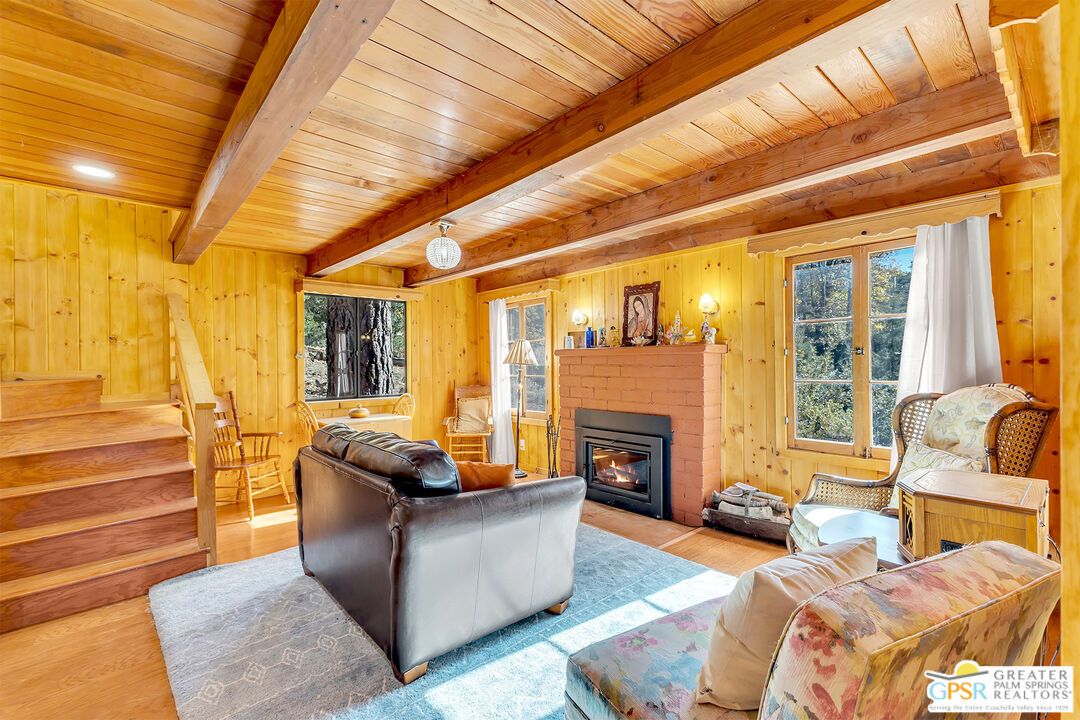 25250 Rim Rock Road Idyllwild, CA 92549 - Photo 24 of 72 a living room with furniture and a fireplace