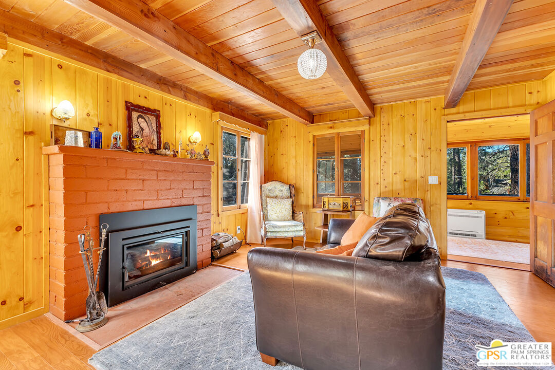25250 Rim Rock Road Idyllwild, CA 92549 - Photo 27 of 72 a living room with furniture a fireplace and next to a window