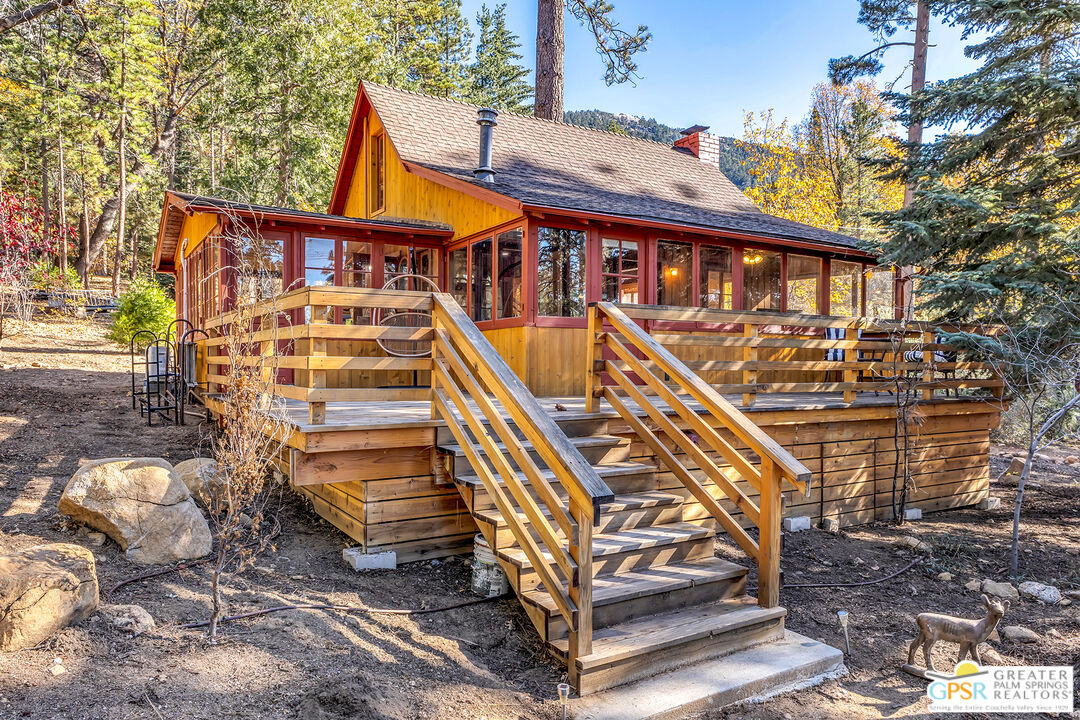 25250 Rim Rock Road Idyllwild, CA 92549 - Photo 51 of 72 a front view of a house with a yard