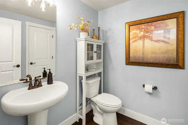 a bathroom with a sink mirror and toilet