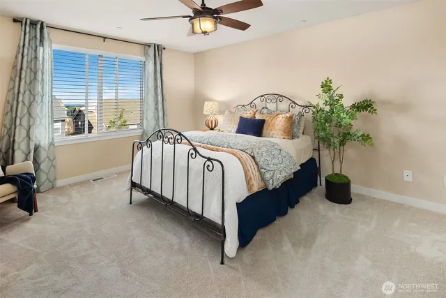 a bedroom with a bed and a potted plant
