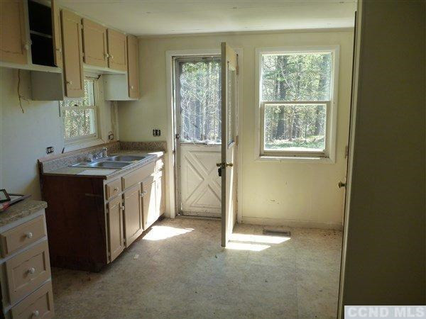 214 Old Rte 23 Cairo, NY 12413 - Photo 3 of 10 a kitchen with stainless steel appliances granite countertop a stove a sink and a refrigerator with wooden floor